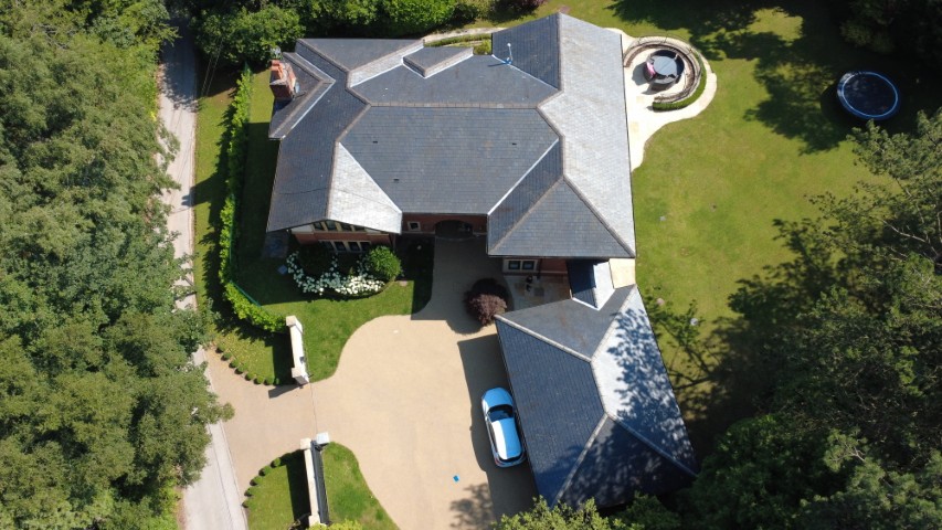 Aerial overview of a large country property with extensive roof areas and grounds.