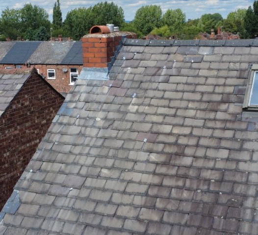 Slate roof covering, original to a property of around 1900, with numerous historic slate repairs and approaching the end of its serviceable life.