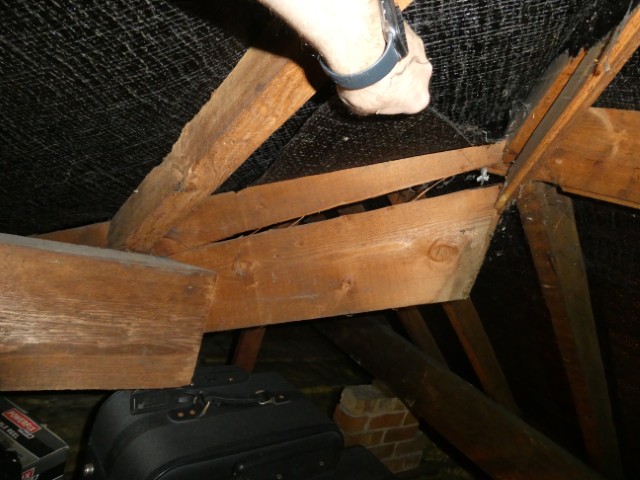 Split noted to a structural hip rafter within a roof space.